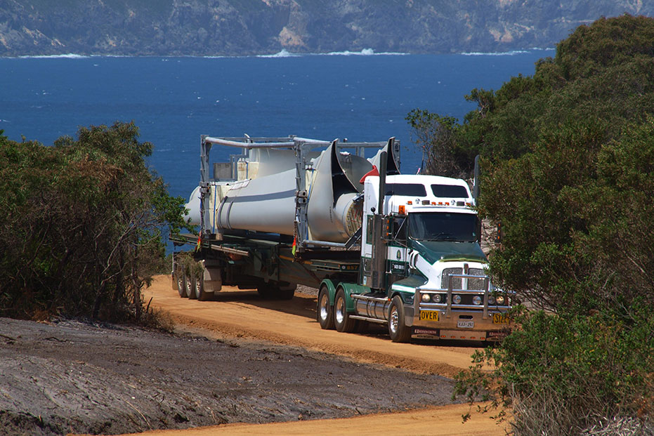 A photo of a semi-trailer delivering the blades or wings to the site.