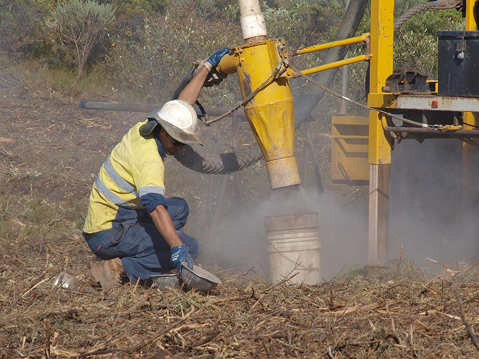 A photo of a person taking soil samples for testing to ensure that the site is suitable.